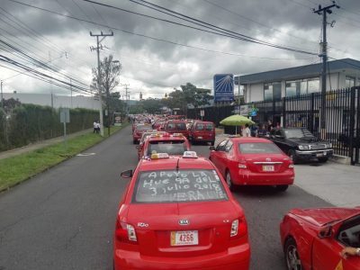Taxistas esperan con luces encendidas y banderas de Costa Rica decisión sobre UBER